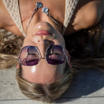 Woman wearing sunglasses with a blue background